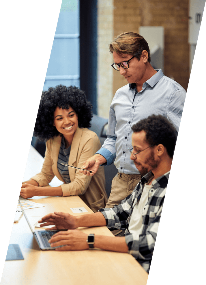 Three people working on a desk